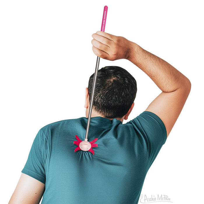 A person using the Axolotl Back Scratcher—an extendable, pink novelty tool shaped like an axolotl—perfect for reaching those tricky back itches and makes a fun, unique gift.