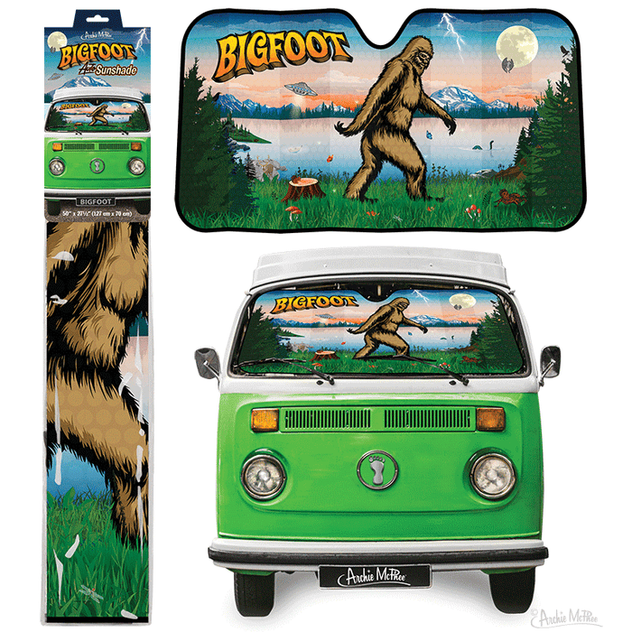 The Bigfoot Auto Sunshade features a forest scene with a Bigfoot illustration beside a green van, offering excellent UV protection for your vehicle.