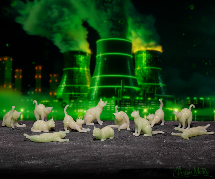Itty Bitty Glow Cats featuring a neon green, industrial backdrop displaying various poses.