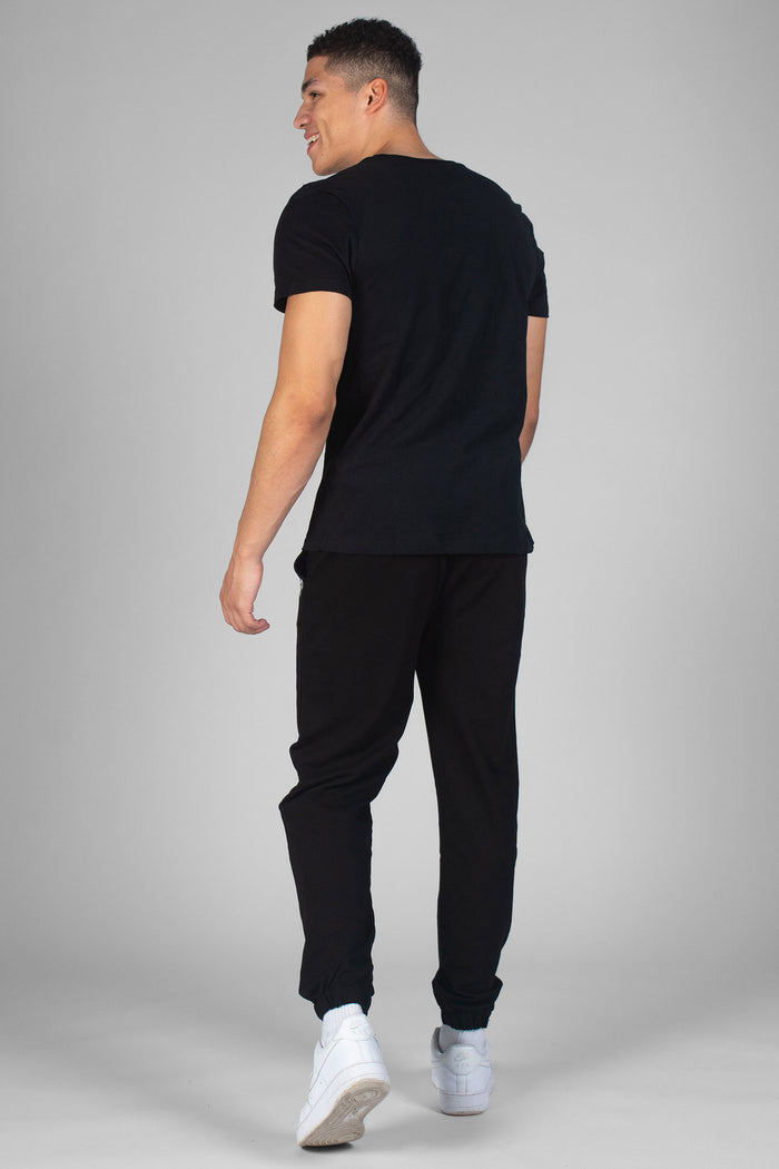 Man wearing black T-Shirt and black track pants
