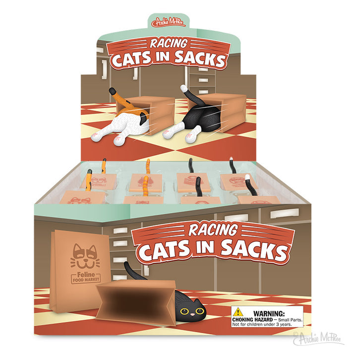 A display box showcases Racing Cats in Sacks, a charming toy featuring cartoon kitty racers emerging from sacks on a checkered floor.