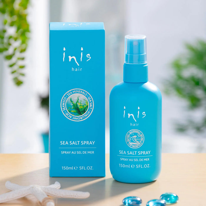Blue bottle and packaging of inis hair sea salt spray on a neutral background