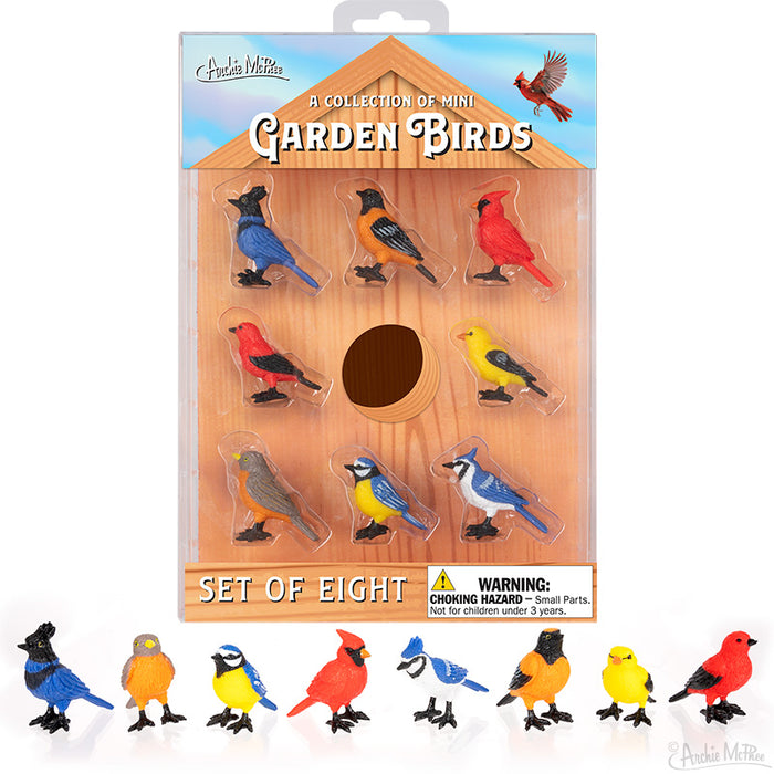 A collection of vibrant Mini Garden Birds, meticulously crafted from soft vinyl, features seven beautifully displayed on a crisp white background with one absent. This set makes a perfect addition to any birdhouse package or garden setting.