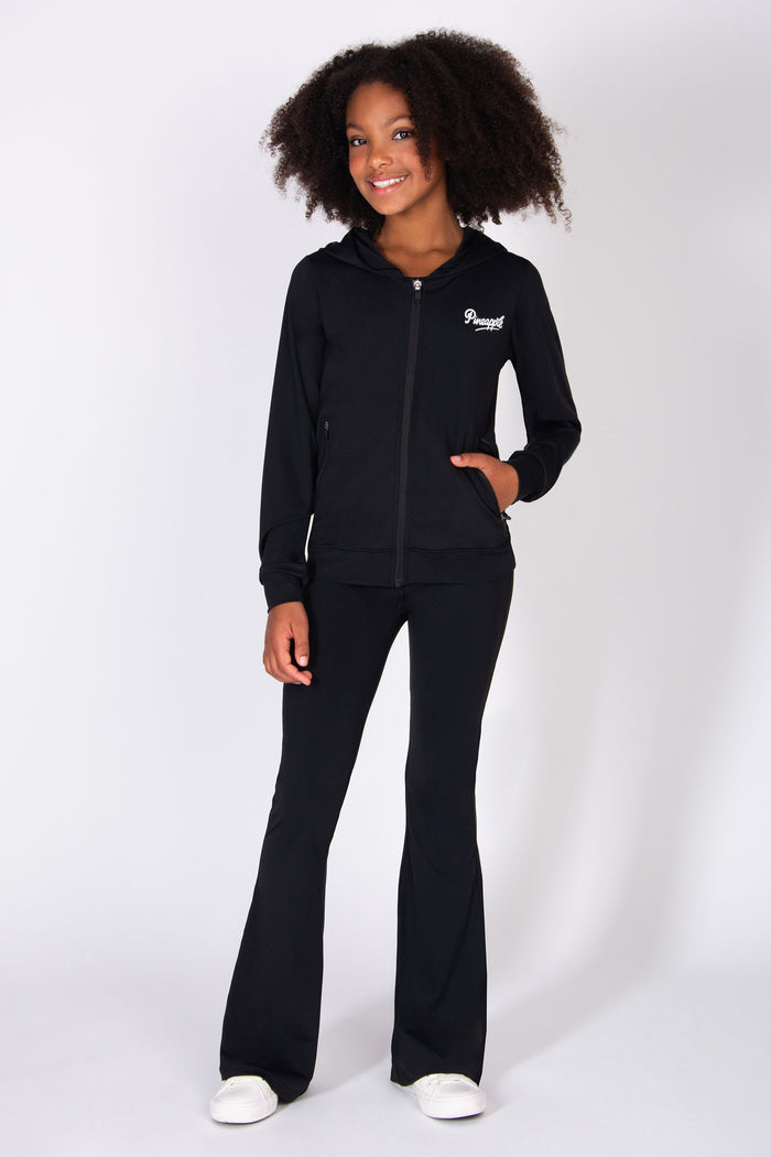 Girls wearing a black tracksuit with a logo on a white background