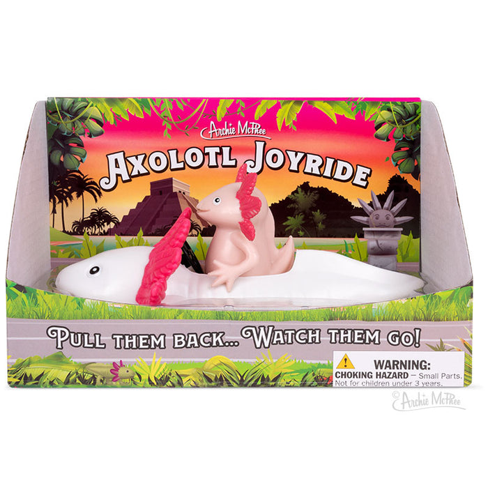 The Axolotl Joyride, crafted from soft vinyl, showcases a delightful pink axolotl toy riding on top of a white one. A safety warning label is placed at the bottom right to ensure safe play. This enchanting pullback car set offers endless enjoyment for both kids and collectors.