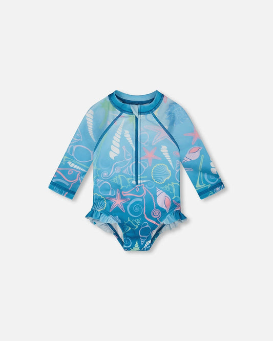 Front flat lay of Deux par Deux baby girl long sleeve rashguard one-piece in blue shell print