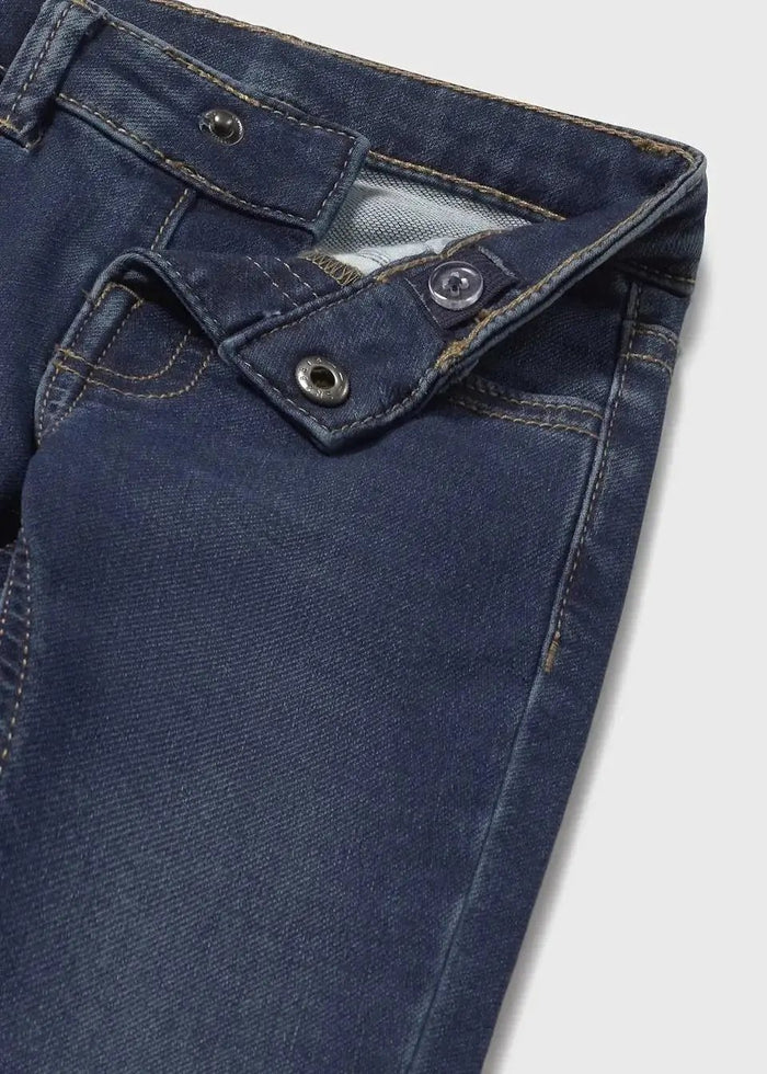 Closeup of Mayoral baby jeans showing back pocket detail, stitching, and dark stretch denim texture.