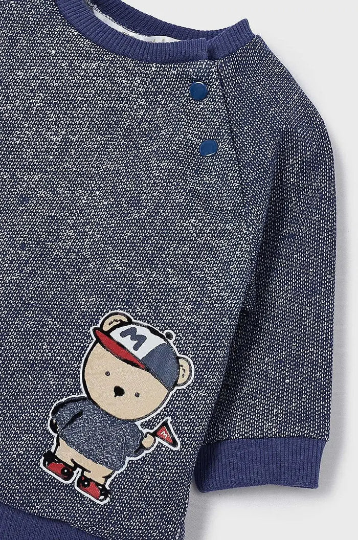 Close-up of Mayoral baby boy navy knit top showing front graphic, buttons, ribbed trim, and soft fabric.