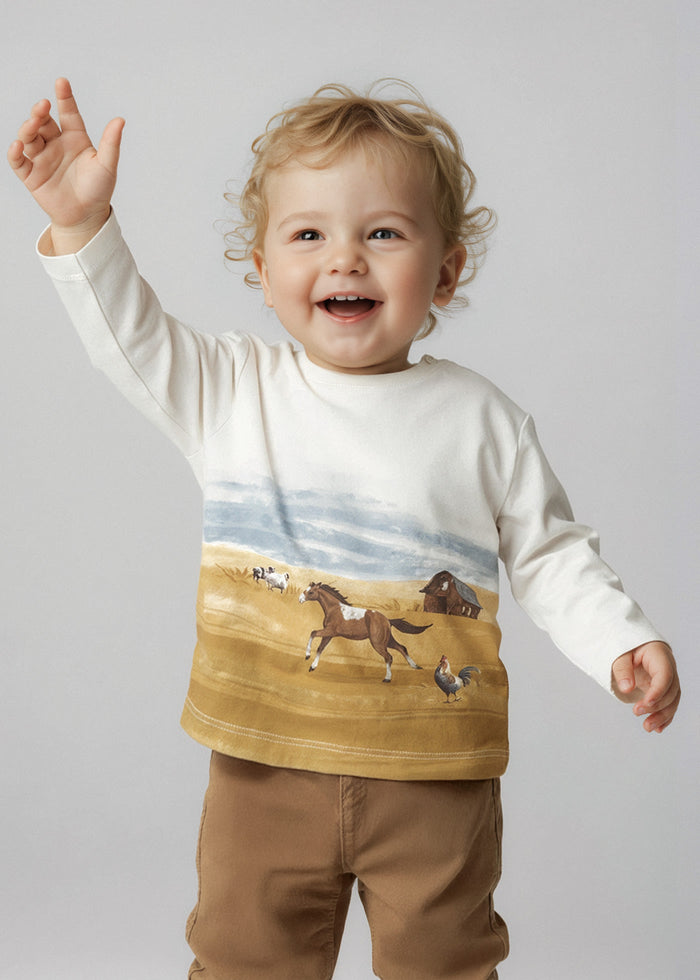Toddler wearing Mayoral landscape t-shirt with casual pants for an everyday baby boy outfit.