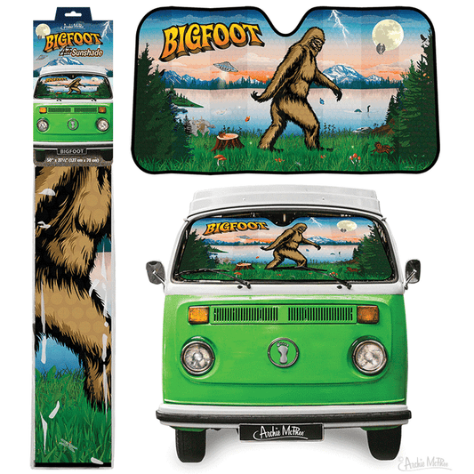 The Bigfoot Auto Sunshade features a forest scene with a Bigfoot illustration beside a green van, offering excellent UV protection for your vehicle.