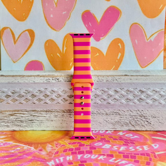 Candy Citrus Stripes Apple Watch band with bold pink and orange horizontal stripes with heart backdrop