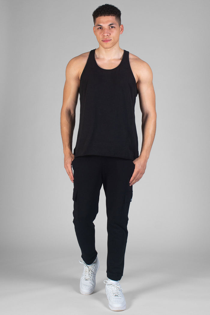 Man wearing black Cargo Joggers and vest