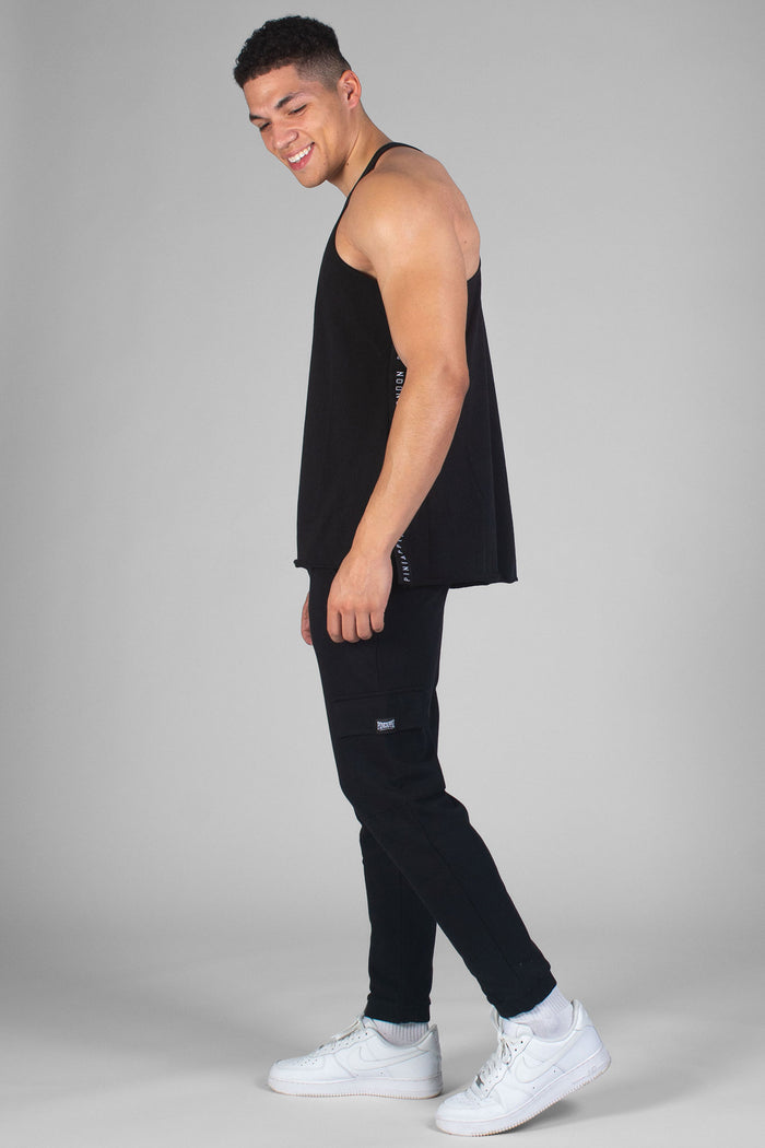 Man wearing black Cargo Joggers sith badge logo and vest