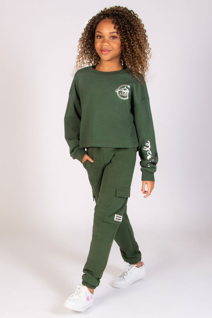 Skylar Blu wearing oversized cargo joggers in khaki with matching sweat top from Pineapple
