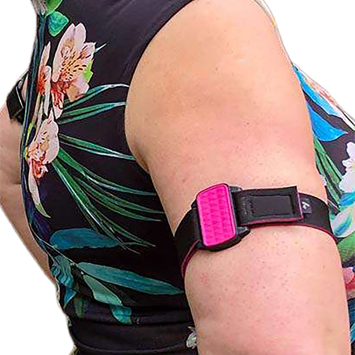 Dexband CGM armband for Dexcom G6 sensors with magenta cover and neoprene strap worn on upper arm.