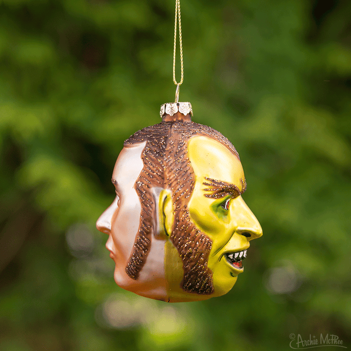 This Dr. Jekyll & Mr. Hyde Ornament, designed as a two-faced figure featuring one human side and the other monstrous, gracefully dangles from a golden thread.