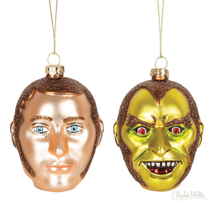 The Dr. Jekyll & Mr. Hyde Ornament features two Christmas decorations: one with a human-like expression, the other with a green, monster-like face. Both are crafted with a touch of glitter, capturing their duality perfectly.