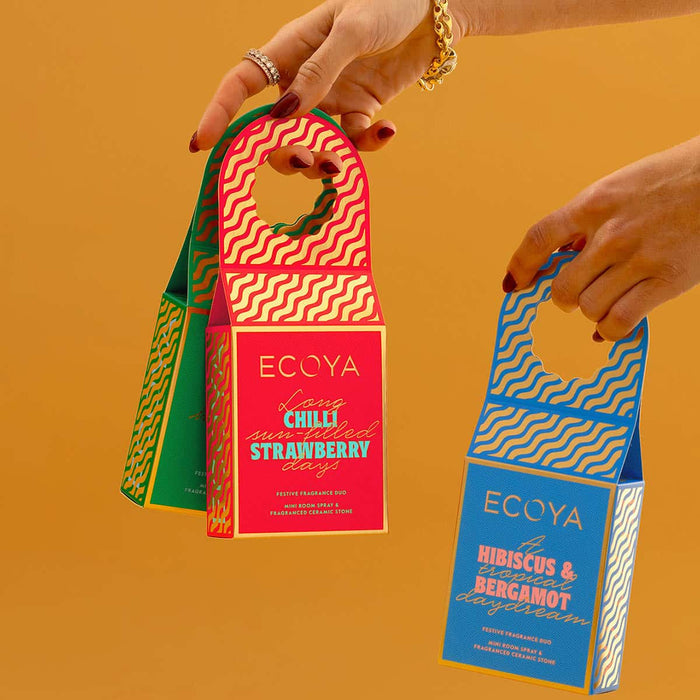 Two ECOYA product packaging held by hands against a yellow background.