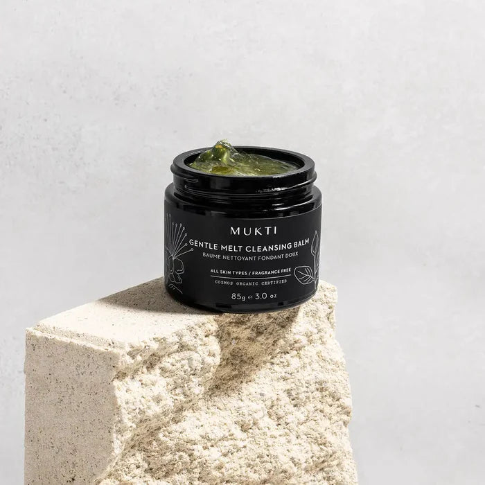 MUKTI Gentle Melt Cleansing Balm with lid off showing jelly-like texture.