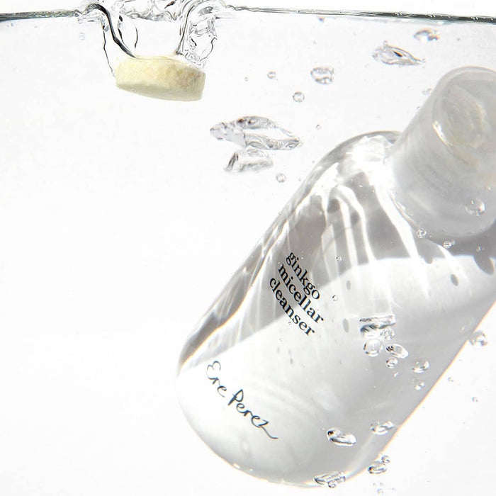 Clear bottle of Ere Perez ginkgo micellar cleanser 37g bottle with a droplet of liquid being poured into water.