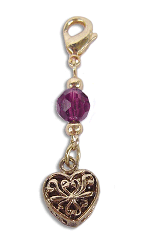 Gold heart charm with filigree detail and red faceted bead and lobster clasp