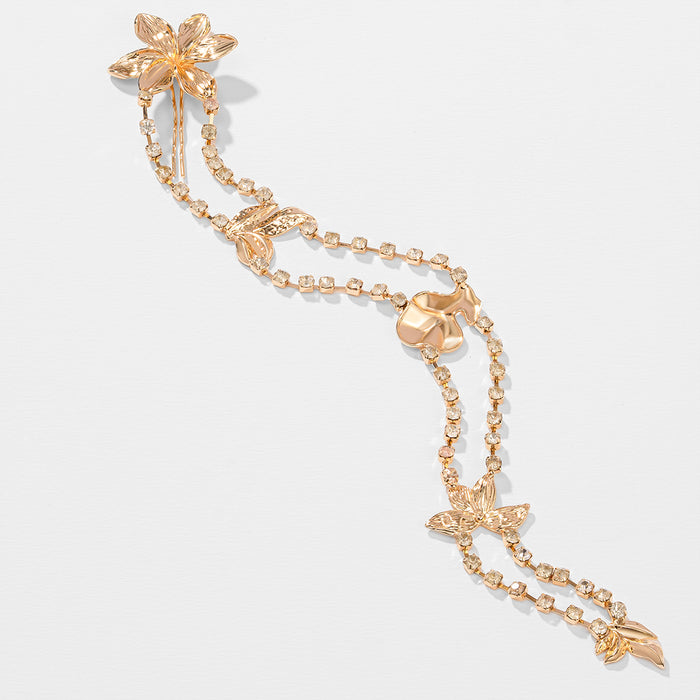 Gold bracelet with floral designs on a white background