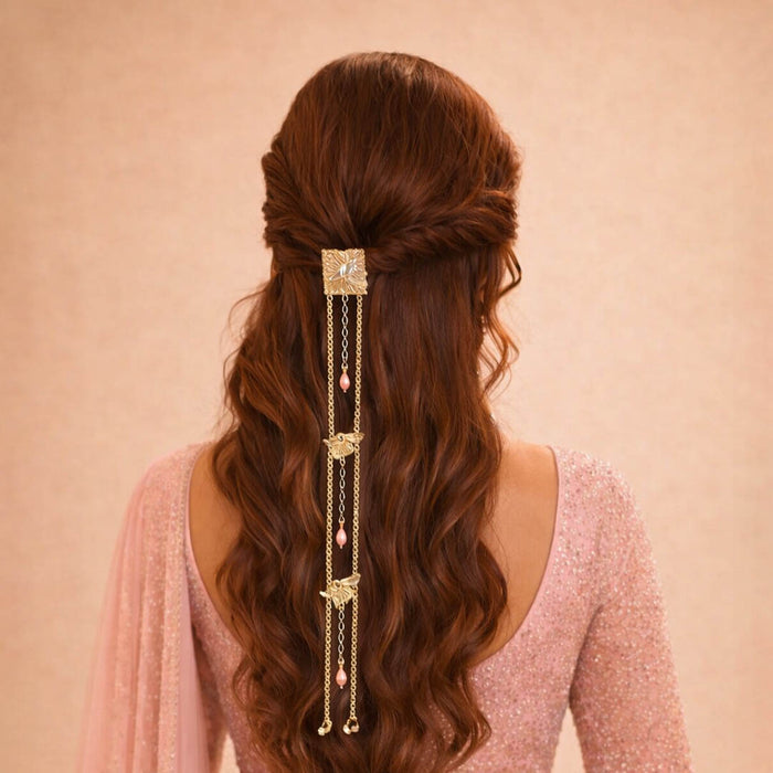 Long wavy hair with a decorative hair accessory on a pink background