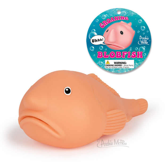 The Groaning Blobfish, designed by Archie McPhee, boasts a round, pink body and is crafted from soft vinyl. It produces an oink-like groan when squeezed.