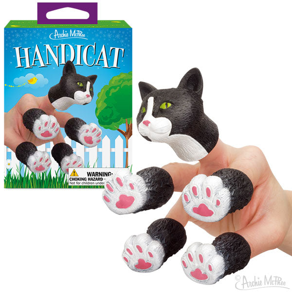 A hand displaying vinyl finger puppets shaped like cats with paws, next to vibrant packaging labeled Handicat.