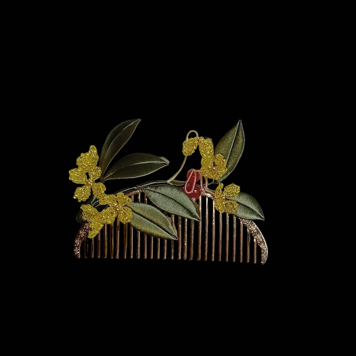 Handcrafted Chanhua thread-wrapped hair comb featuring golden Osmanthus flowers, green leaves, and a small red-accented bunny motif on a gold-tone comb.