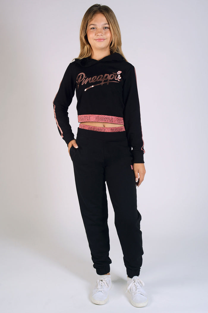 Girl wearing black Jacquard Tape Joggers and matching crop hoodie