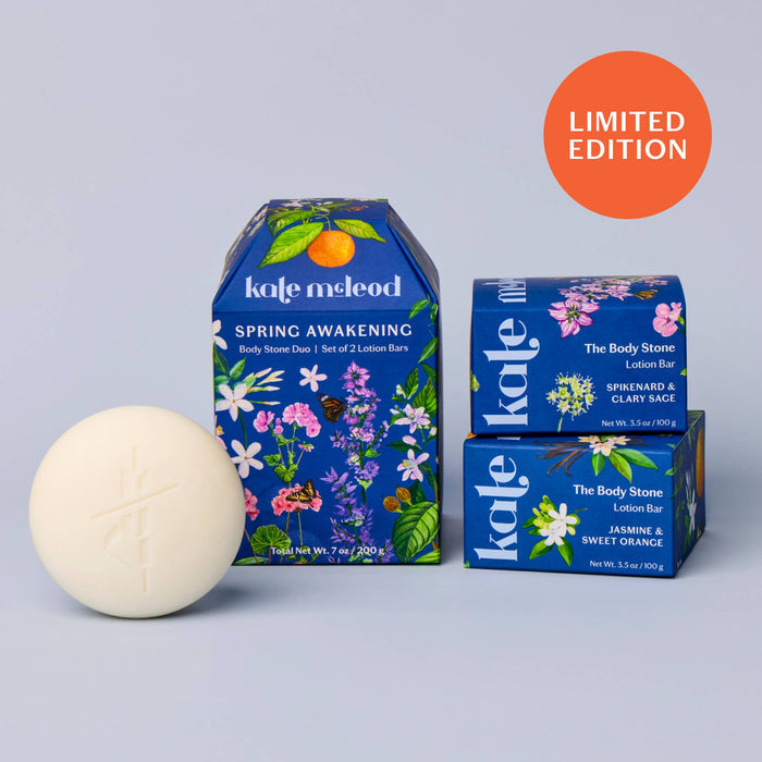 Kate MeLeod body stone and lotion bars with packaging on a gray background
