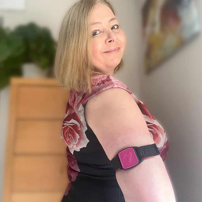 Libreband CGM armband for FreeStyle Libre 2 with magenta heart cover and neoprene strap worn on upper arm. LML2388, LML2371, LML2920, LML4481.