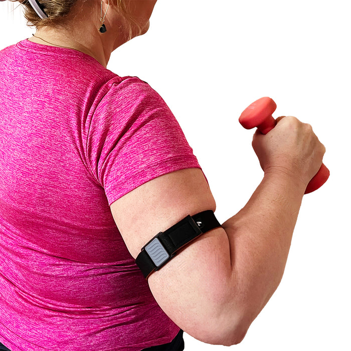 Libreband CGM Armband for Freestyle Libre 3. Pewter cover with wave design. Shown on upper arm of woman exercising. LML4795, LML3828, LML3811, LML3804.
