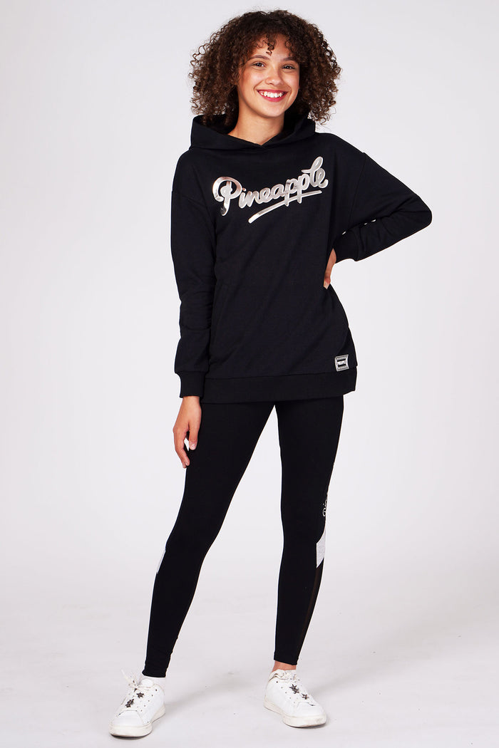 Girl wearing Black Longline Logo Hoodie and black leggings