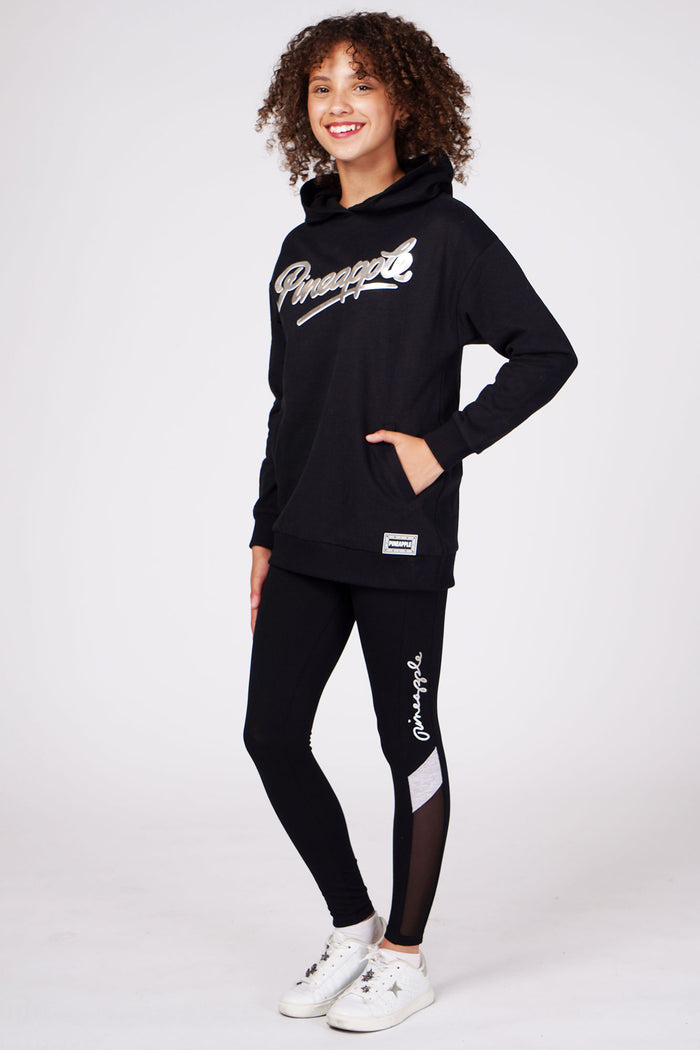 Girl wearing Black Longline Logo Hoodie and mesh panel black leggings