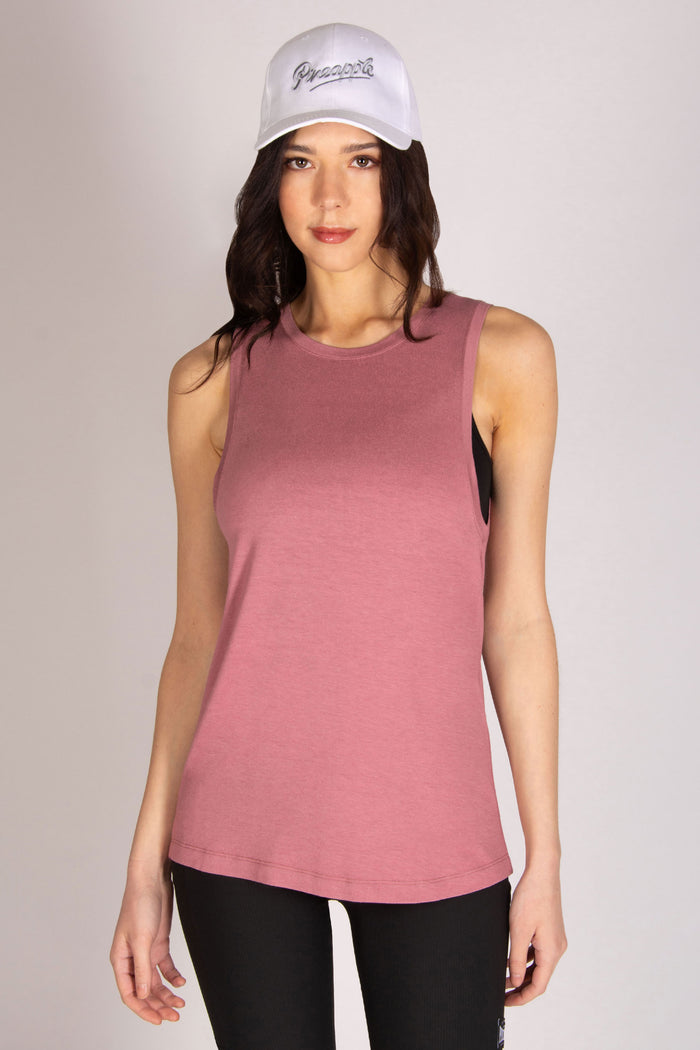 Women's pink dropped armhole vest with black Pineapple Dance cap and cycling shorts