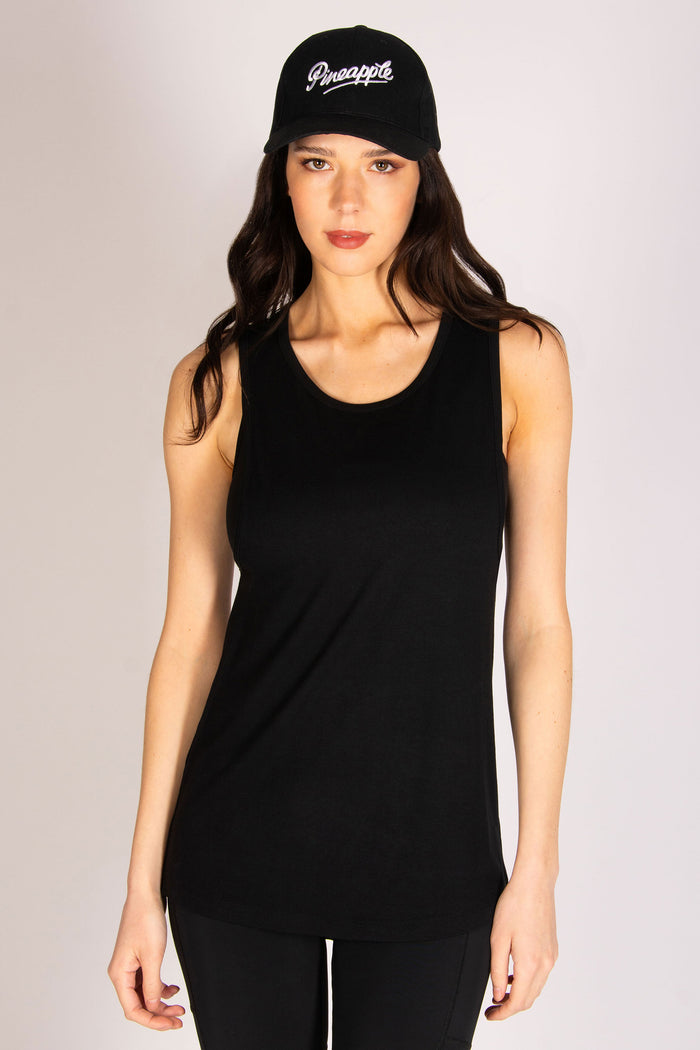 Women's black dropped armhole vest with black Pineapple Dance cap and cycling shorts
