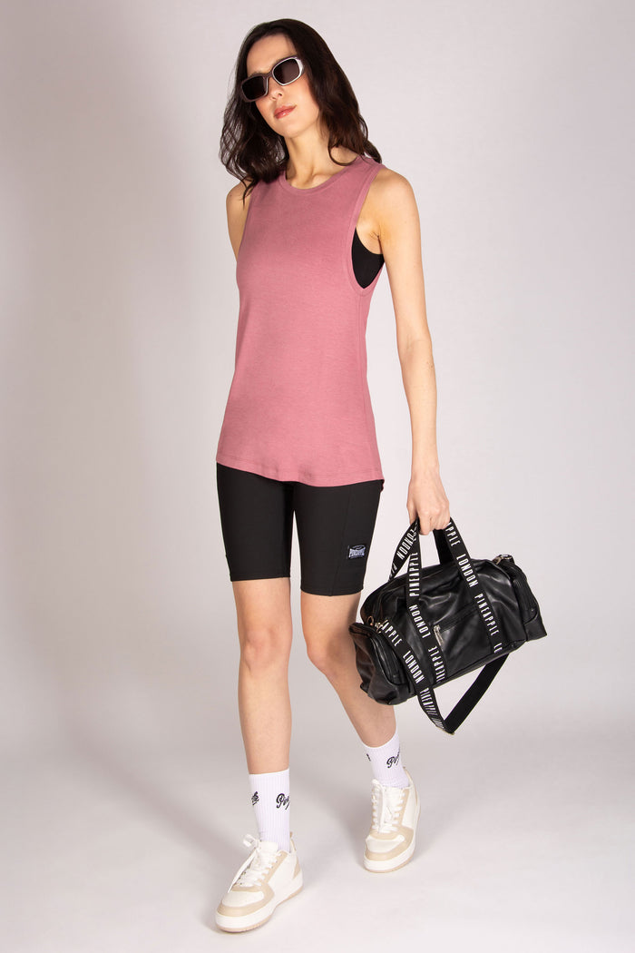 Pink long vest top with large arm hole, scooped back for women, made in soft jersey fabric.
