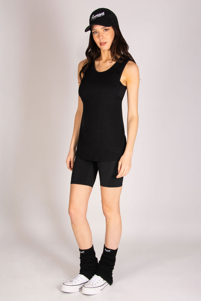 Martyna Balsam modelling for Pineapple wearing black gym vest with dropped armholes.
