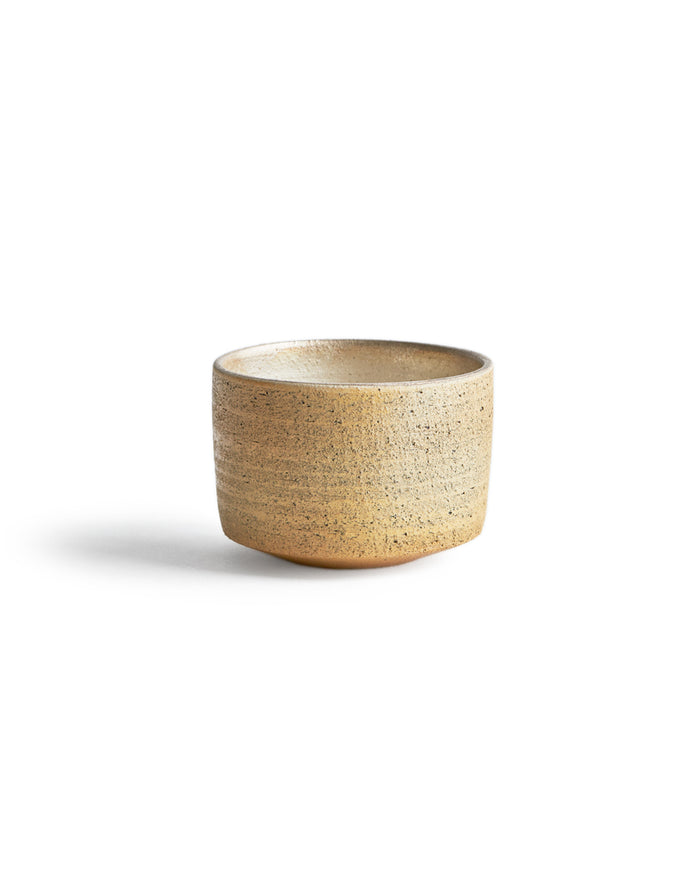 Silhouetted image of the uchugin silver matcha bowl against white background.