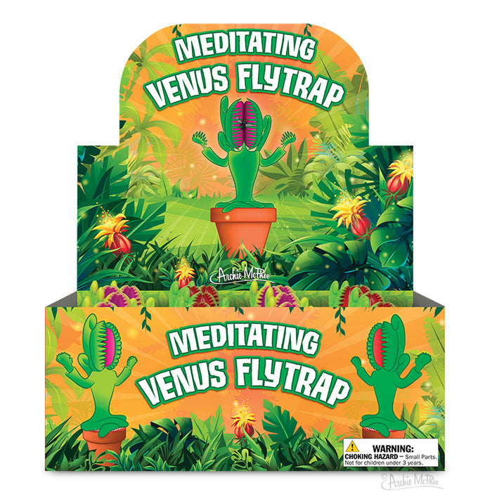 The Meditating Venus Flytrap toy features colorful, jungle-themed packaging that embodies the spirit of mindful carnivory. It includes a warning label for safe play, offering an engaging and thoughtful experience for young adventurers.