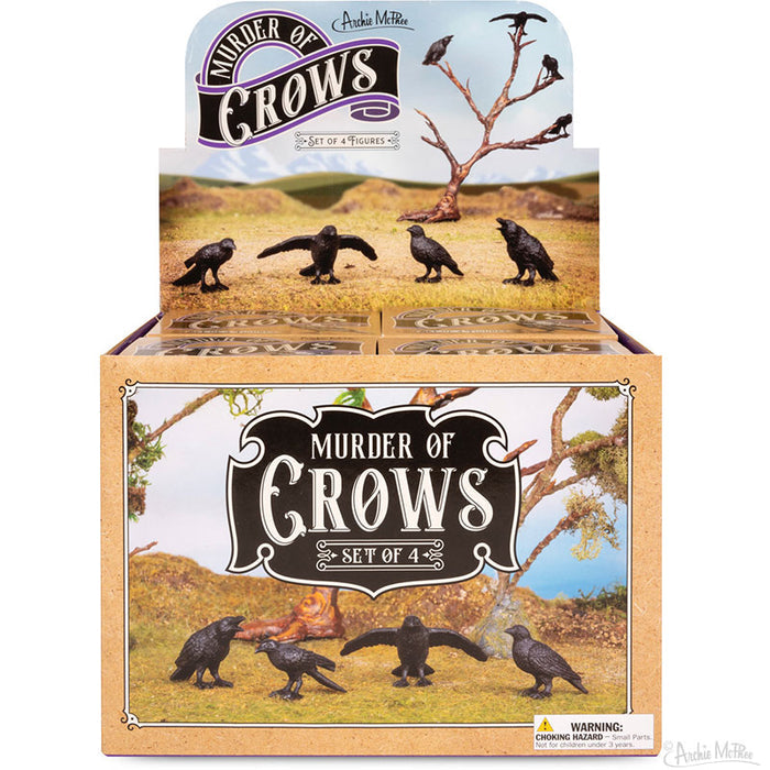 Display box of the "Murder of Crows" figurine set, featuring four intricately detailed vinyl crows against a scenic background.
