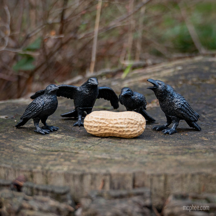 The "Murder of Crows" features four intricately detailed decorative crows encircling a peanut on a tree stump.