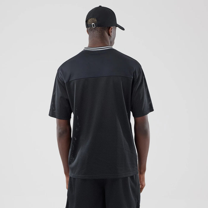 The model is wearing this New Era Mesh Oversized T-Shirt in black. 2