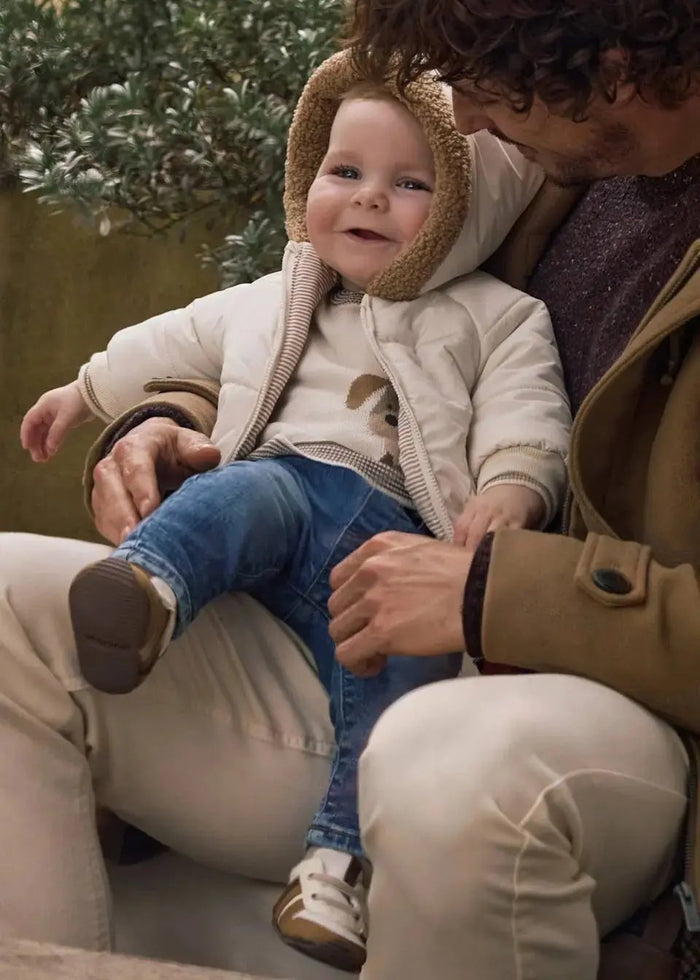 Baby wearing Mayoral Light Denim jeans for a soft everyday newborn boy outfit.