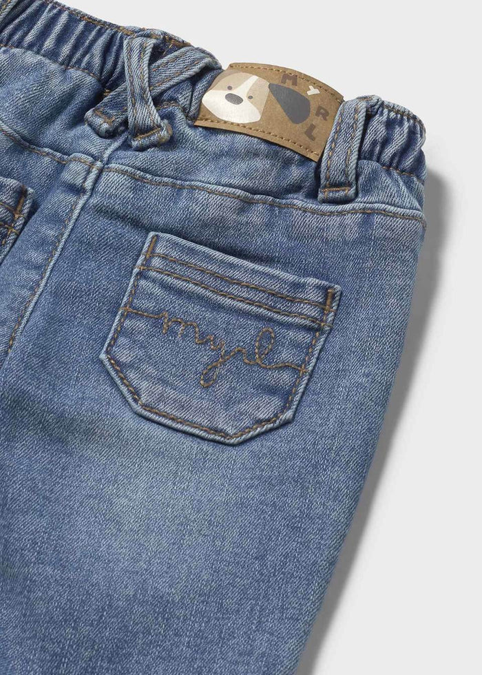 Closeup of Mayoral baby boy jeans showing pocket detail, stretch denim texture, and waistband.