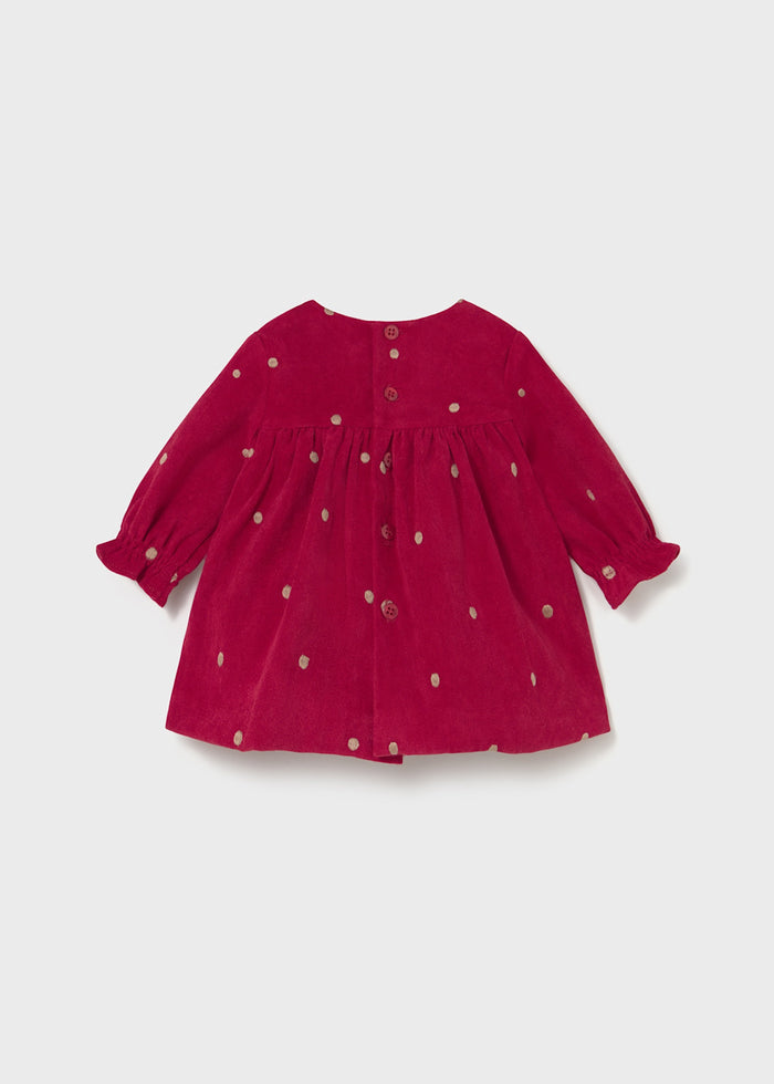 Back view of Mayoral newborn girl red polka dot dress showing long sleeves and easy baby fit.