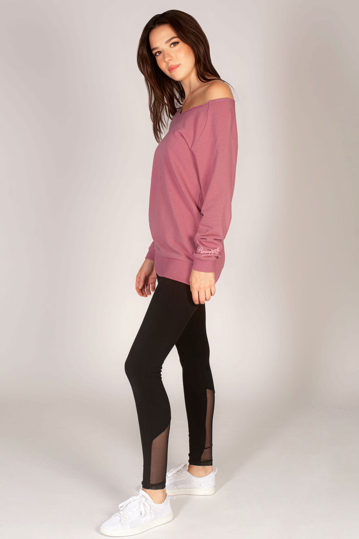 Martyna Balsam wearing off-shoulder sweater in pink paired with black leggings