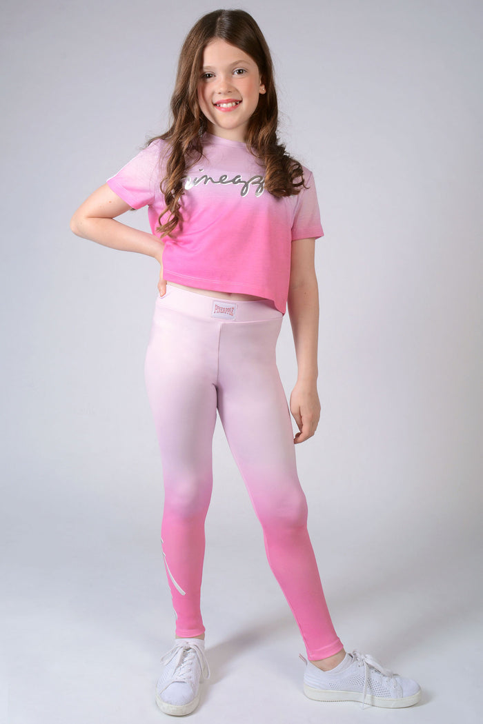 Girl wearing candyfloss pink Ombré Leggings with silver logo and matching t-shirt